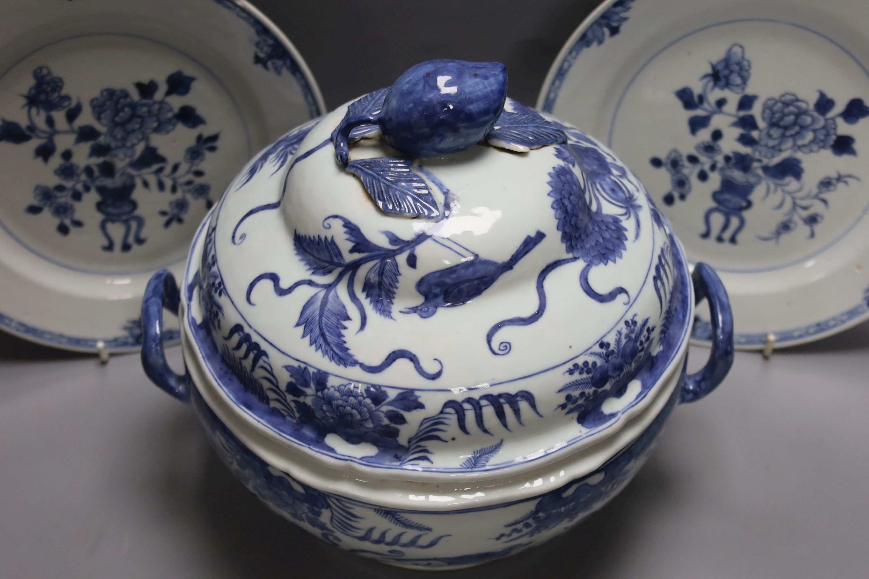An 18th century Chinese Export blue and white octagonal tureen and cover, decorated with birds and flowers, a pair of similar sauceboats and five plates decorated with urns of flowers